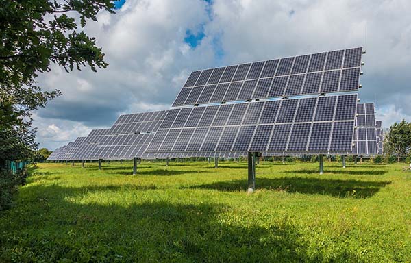 Environment is important! Image of solar panels in a grassy field.